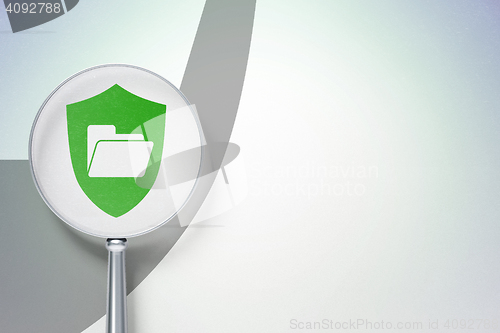 Image of Business concept:  Folder With Shield with optical glass on digital background