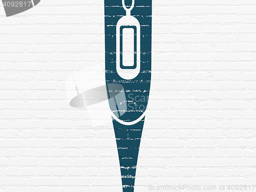 Image of Healthcare concept: Thermometer on wall background