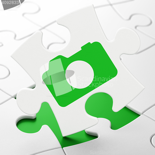 Image of Tourism concept: Photo Camera on puzzle background