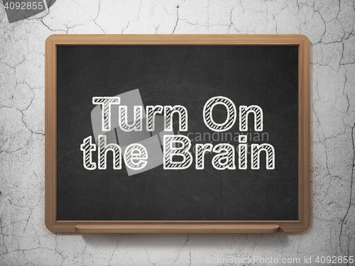 Image of Studying concept: Turn On The Brain on chalkboard background