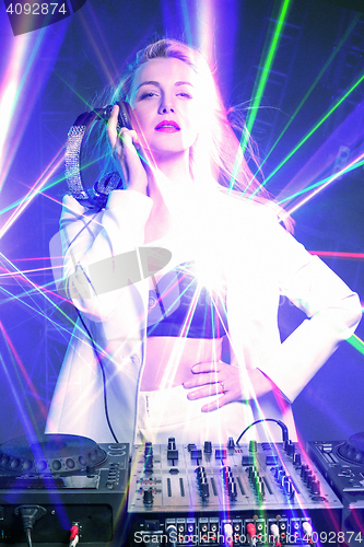 Image of Beautiful blonde DJ girl on decks - the party,