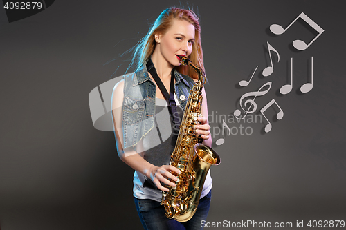 Image of beautiful blonde as saxophonist woman 