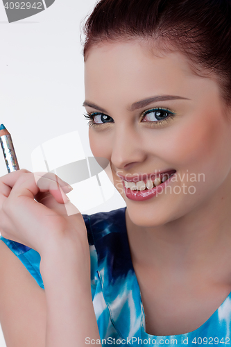 Image of Young Woman Applying Cosmetics