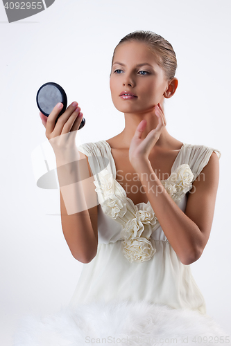 Image of Young Woman Applying Cosmetics