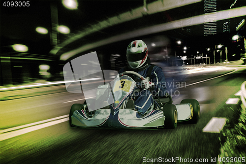 Image of Karting - driver in helmet on kart circuit