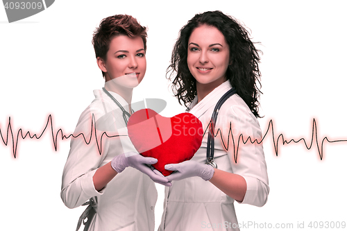 Image of Two woman doctor holding a red heart