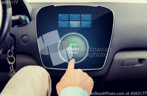 Image of close up of man using starter application in car