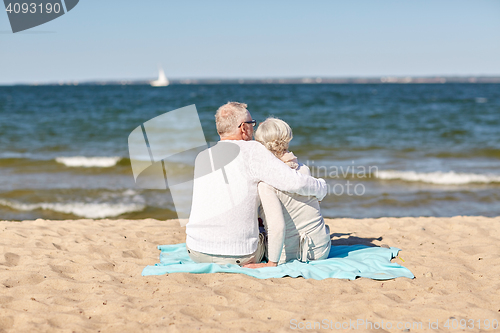 Image of happy senior couple hugging on summer beach