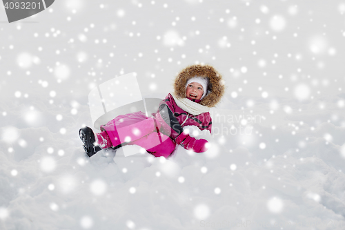 Image of happy little kid or girl in winter clothes on snow