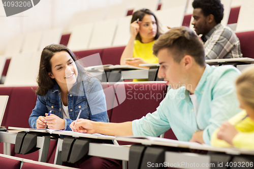 Image of group of students with notebooks in lecture hall