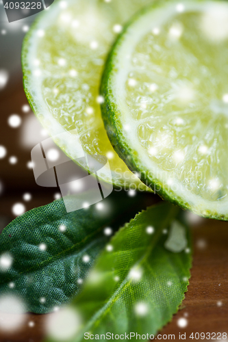 Image of lime slices on wooden table