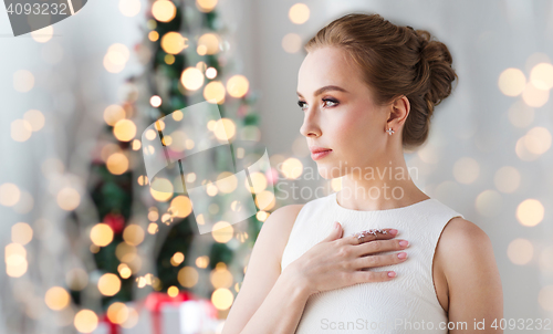 Image of woman wearing diamond jewelry for christmas