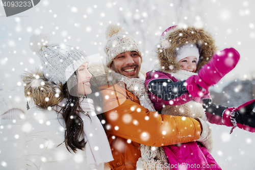 Image of happy family with child in winter clothes outdoors