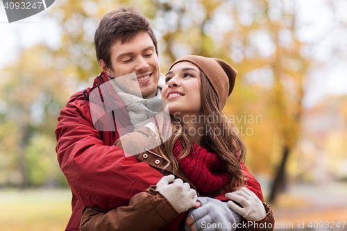 Image of happy young couple hugging in autumn park