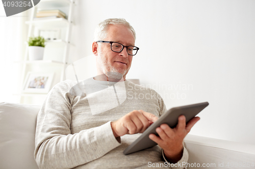 Image of senior man with tablet pc at home