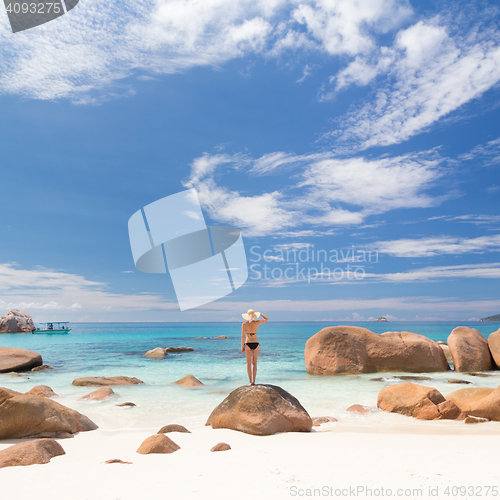 Image of Woman enjoying Anse Lazio picture perfect beach on Praslin Island, Seychelles.