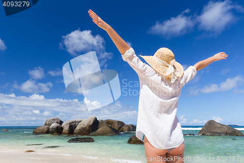 Image of Woman enjoying Anse Lazio picture perfect beach on Praslin Island, Seychelles.