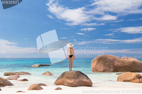 Image of Woman enjoying Anse Lazio picture perfect beach on Praslin Island, Seychelles.