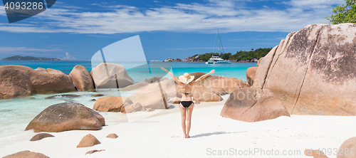 Image of Woman enjoying Anse Lazio picture perfect beach on Praslin Island, Seychelles.