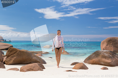 Image of Woman enjoying Anse Lazio picture perfect beach on Praslin Island, Seychelles.