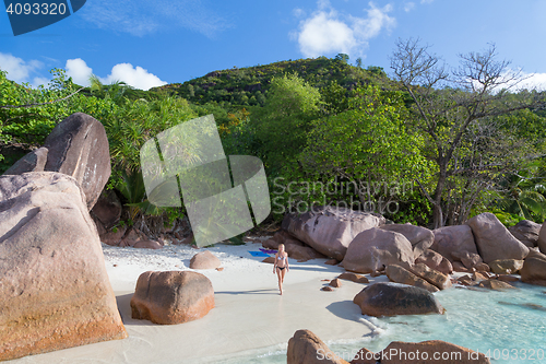 Image of Woman enjoying Anse Lazio picture perfect beach on Praslin Island, Seychelles.