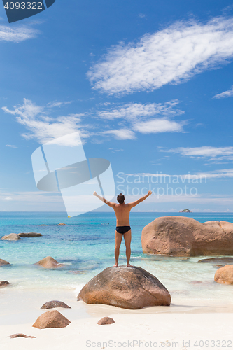 Image of Woman enjoying Anse Lazio picture perfect beach on Praslin Island, Seychelles.