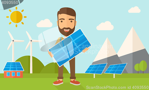 Image of Man holding a solar panel.