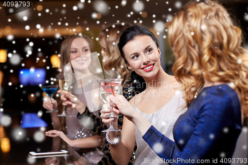 Image of happy women with drinks at night club