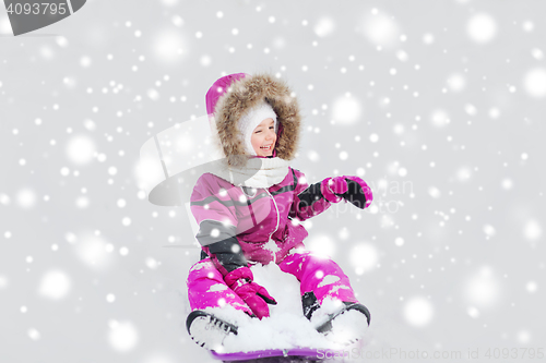 Image of happy little kid on sled outdoors in winter