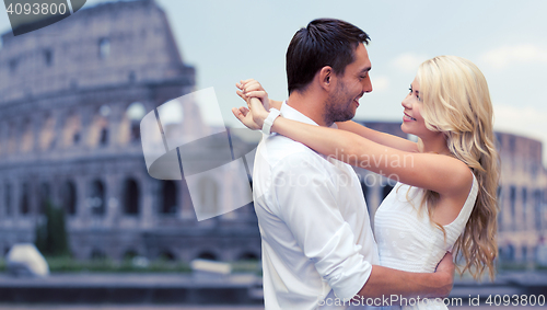 Image of happy couple hugging over coliseum