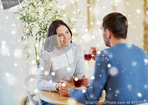 Image of happy couple drinking tea at cafe