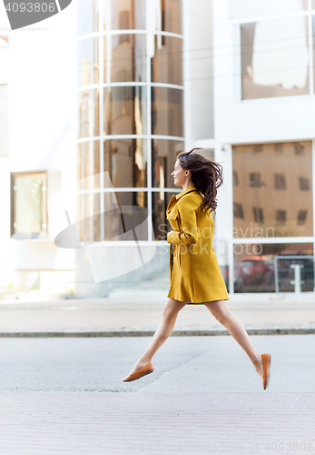 Image of happy young woman or teenage girl on city street