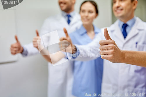 Image of close up of doctors at hospital showing thumbs