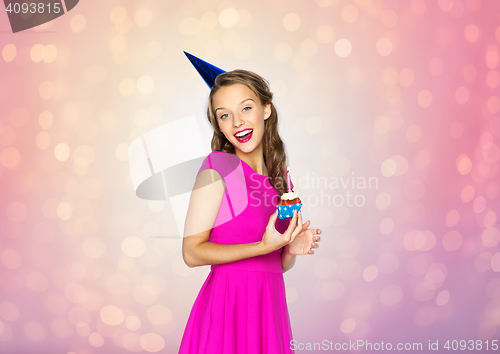 Image of happy woman or teen girl with birthday cupcake