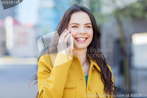 Image of smiling young woman or girl calling on smartphone