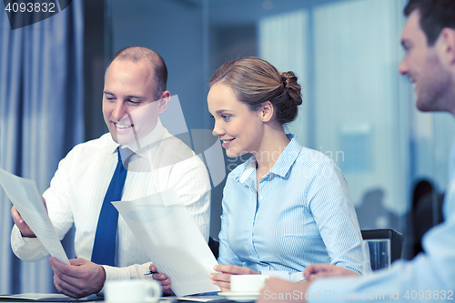 Image of business people with papers meeting in office