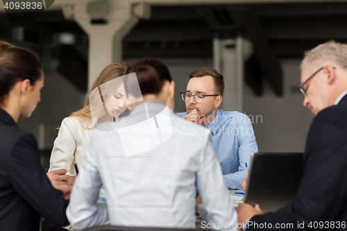 Image of smiling business people meeting in office