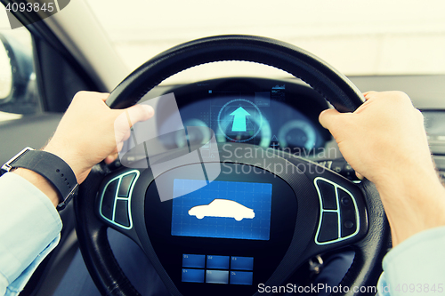 Image of close up of man driving car with icon on computer