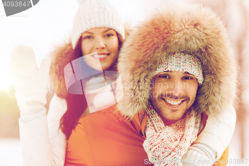 Image of happy couple having fun over winter background