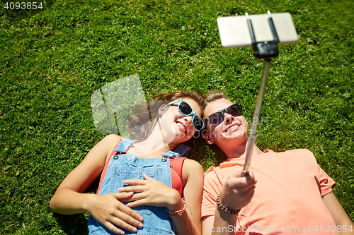 Image of happy couple taking selfie on smartphone at summer