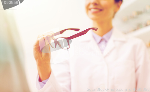 Image of close up of optician with glasses at optics store