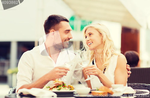 Image of happy couple clinking glasses at restaurant lounge