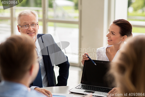 Image of business people with laptop meeting in office