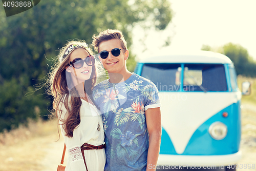 Image of smiling young hippie couple over minivan car