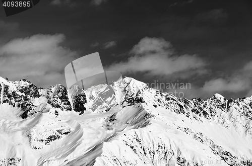 Image of Black and white view on snowy mountains in sunny day
