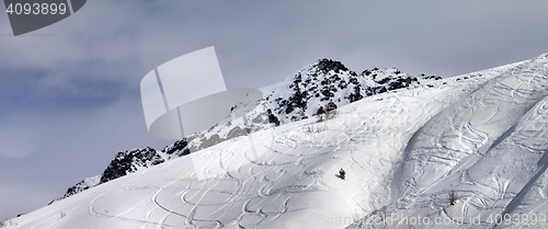 Image of Panoramic view on off-piste slope with traces from skis and snow