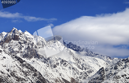 Image of Snow winter mountains and blue sky with clouds at sun day