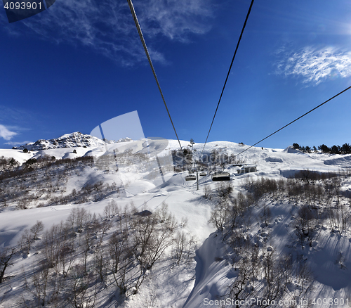 Image of Chair-lift at ski resort in sun winter day