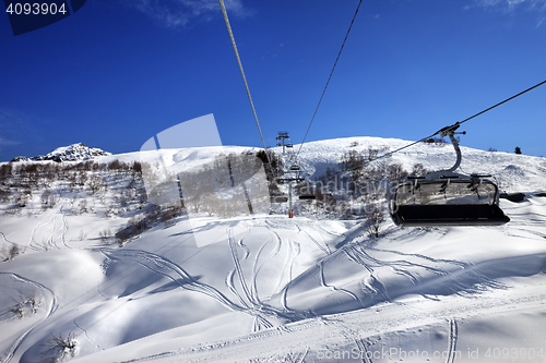 Image of Chair-lift at ski resort in sun winter day