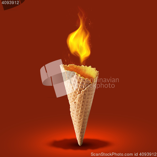 Image of wafer cone with fire on color background